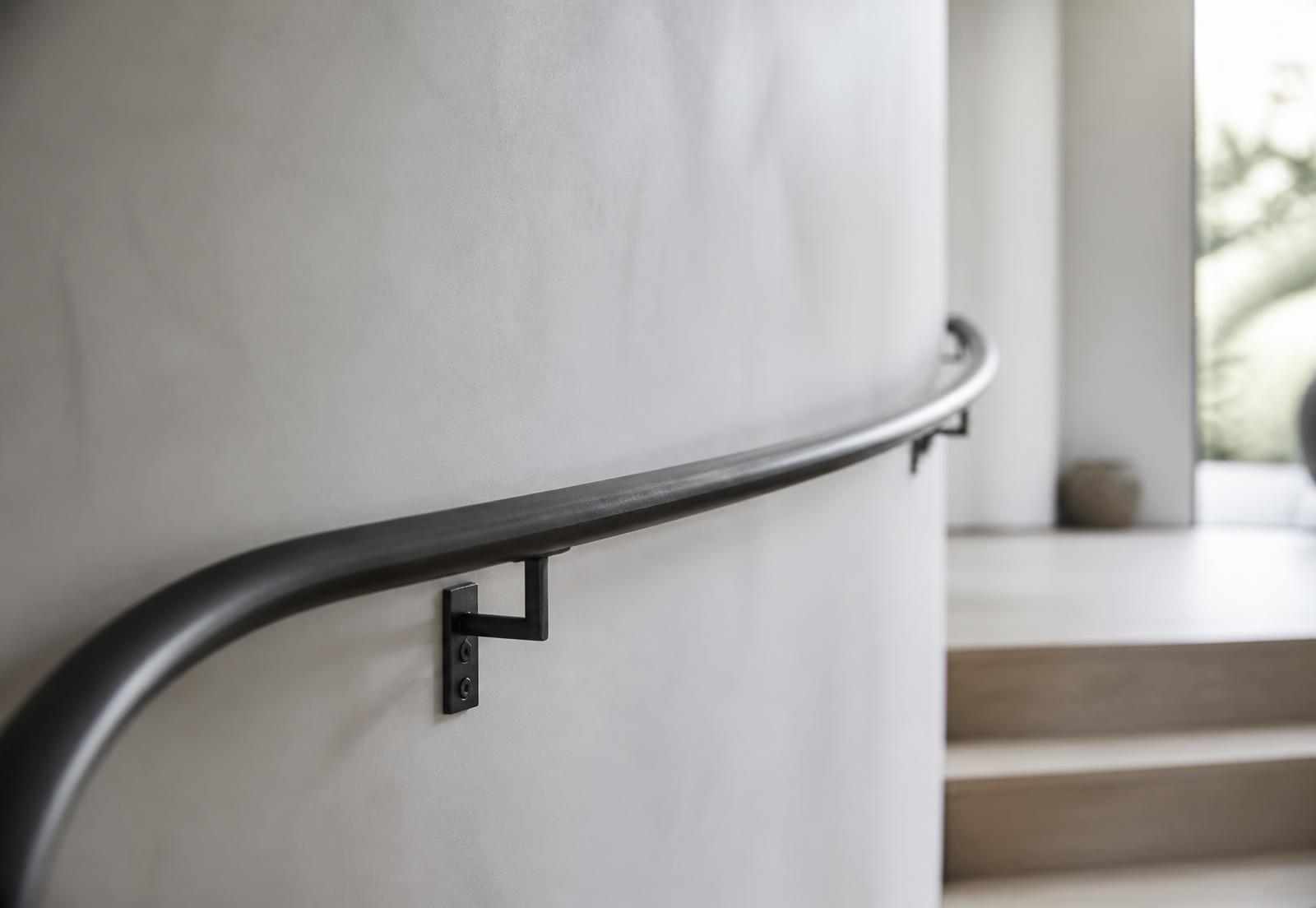 Detail of a hand-formed blackened steel handrail